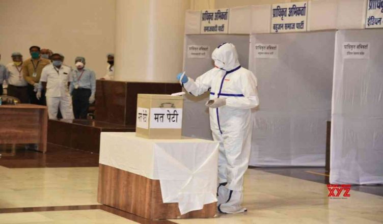 Corona positive MLA Kunal Choudhary casts his vote for Rajya Sabha election wearing a PPE suit at the assembley complex
